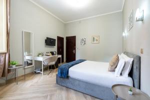 a bedroom with a bed and a desk and a table at Portafortuna GUESTHOUSE - close to COLOSSEUM in Rome