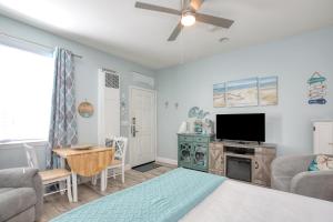 a living room with a bed and a flat screen tv at Pacific Plaza #505 - Coastal Gem - StudioD-Q in Oceano