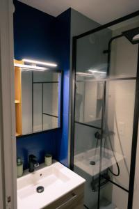 a bathroom with a white sink and a mirror at La parenthèse du sud Parking calme et confort in Valence +13 photos