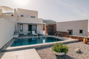a backyard with a swimming pool and a house at Makrikythera Luxury Sea House in Kýthira