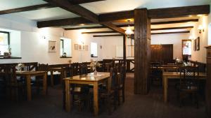 a dining room with wooden tables and chairs at Penzion Tyra - Stáje in Tyra