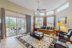 a living room with a couch and a table at Cypress Point Condominiums at Craft Farms #306B in Gulf Shores