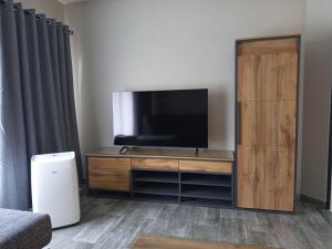 a entertainment center with a flat screen tv in a room at Hantam Suites in Centurion