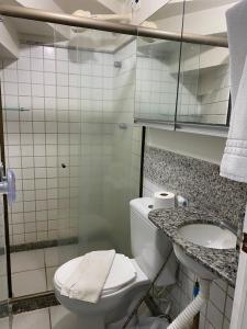 a bathroom with a toilet and a sink at Nannai Residence - Muro Alto - Porto de Galinhas in Porto De Galinhas