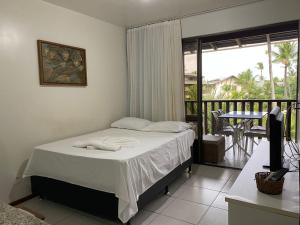 a bedroom with a bed and a balcony at Nannai Residence - Muro Alto - Porto de Galinhas in Porto De Galinhas +17 photos
