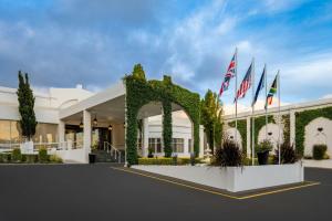 a building with three flags in front of it at Lord Charles Hotel, Somerset West, a Tribute Portfolio Hotel in Somerset West