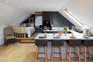 a kitchen and living room with a table and chairs at Meadow View Barn - Ryde in Saint Helens
