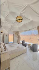 a bedroom with a large bed in a tent at RUM BUBBLES VIEW lUXURY CAMP in Wadi Rum