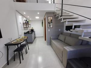 a living room with a couch and a table at Lofts Indaiatuba in Indaiatuba