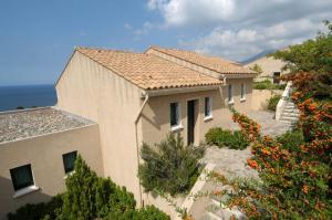 a large building with a view of the ocean at Résidence Costa d'Oru in Saint-Florent
