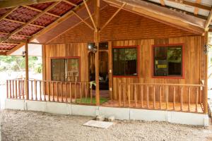 a house being constructed with a porch and windows at ROQUI Cozy Beachfront Cabin in Uvita