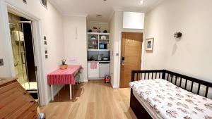 a bedroom with a bed and a table in a room at 301 Self contained studio in heart of London in London
