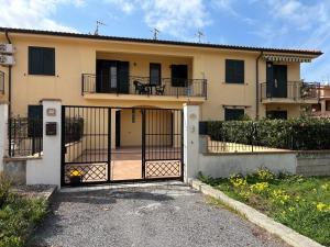 a house with a gate in front of it at Villa Romano Cirella in Cirella