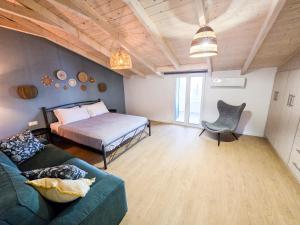 a living room with a bed and a couch at Casa Burano in Lefkada Town