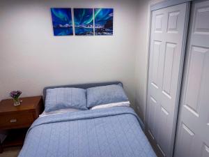 a bedroom with a bed with two pillows next to a door at Modern 1-Bedroom Cozy Retreat in San Carlos