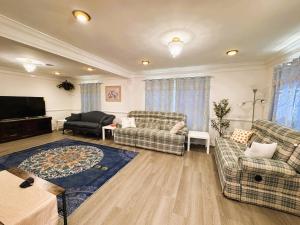 a living room with two couches and a tv at Entire Family-friendly 4 BR Cozy Unit , Metro walk in Rockville