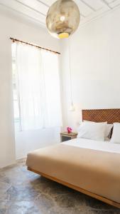 A bed or beds in a room at LIVIN Hydra Garden Suite