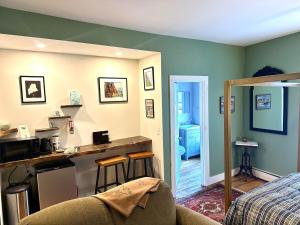 a room with a bed and a kitchen with a counter at The Downtown Downeast Room in Portland