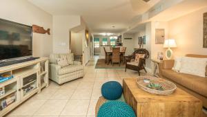 a living room with a couch and a tv at 701 Mariners Club in Key Largo