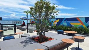 a table and chairs with a tree on a patio at Skylux 3003 in Rio de Janeiro