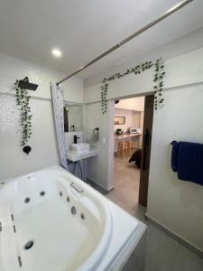 a large white bath tub in a bathroom at Comoda habitación centrica in Aguascalientes