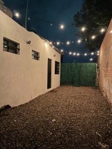 an alley with a building with a door and lights at Comoda habitación centrica in Aguascalientes