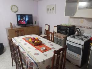 a kitchen with a table with a bowl of fruit on it at Departamento Storni Rafaela in Rafaela