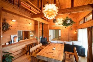 a living room with a wooden table and a couch at THE HILL Katsuura in Katsuura