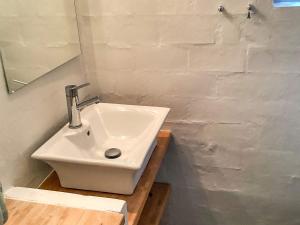 a white sink in a bathroom with a mirror at 6 person holiday home in Grenaa in Grenå +39 photos