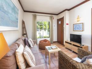 a living room with a couch and a tv at Seaside apartment in Benagil with terrace in Benagil