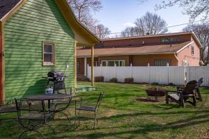 a yard with a table and chairs and a house at The Green Street Getaway in South Haven
