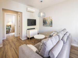 a living room with a couch and a table at Modern apartment with sea views, terrace in Benagil