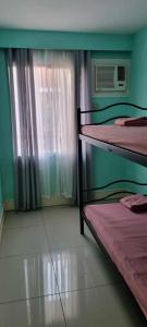 a room with two bunk beds and a window at Elegant 2BR Condo unit with free WiFi in Anabu Primero +18 photos