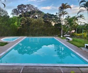a swimming pool with blue water in a yard at Tu Espacio en Ibague in Ibagué