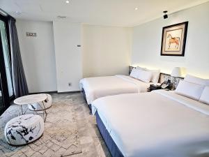 Posteľ alebo postele v izbe v ubytovaní Suncheon Hotel Gite