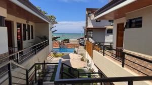 a balcony with a view of the ocean at Elmarie Beach Resort in San Fabian +25 photos
