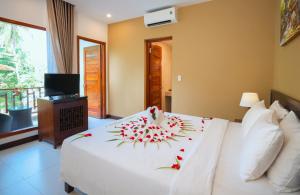 Postel nebo postele na pokoji v ubytování Nadine Phu Quoc Resort & Spa