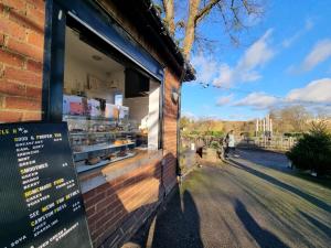 a bakery window with a sign in front of it at Stylish Small Double with Free Parking near Hampton Court-R1 in West Molesey