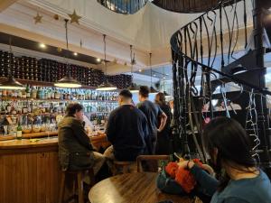 a group of people sitting at a bar at Stylish Small Double with Free Parking near Hampton Court-R1 in West Molesey