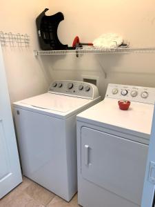 a laundry room with a washer and dryer at Calming & Relaxing condo in the center of MB in Myrtle Beach +29 photos