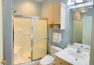 a bathroom with a shower and a toilet and a sink at Calming & Relaxing condo in the center of MB in Myrtle Beach