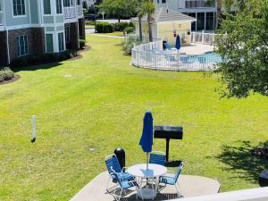 a table and chairs with a keyboard on a lawn at Calming & Relaxing condo in the center of MB in Myrtle Beach