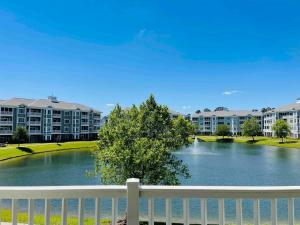 a view of a lake with apartment buildings at Calming & Relaxing condo in the center of MB in Myrtle Beach
