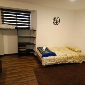 a bedroom with a bed and a clock on the wall at Suite La Pergola - El Renacimiento Suites in Cuenca +2 photos