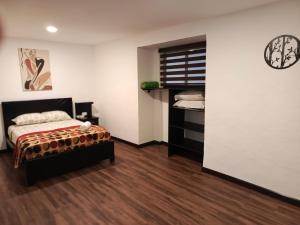 a bedroom with a bed and a closet in a room at Suite La Pergola - El Renacimiento Suites in Cuenca