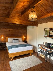 a bedroom with a bed and a wooden ceiling at Jacaranda Cottage 5 min by Train or 7 min drive to Parramatta City in Wentworthville