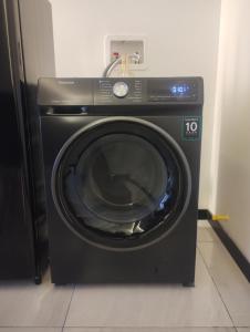 a black washing machine sitting in a room at Departamento en Chihuahua in Chihuahua