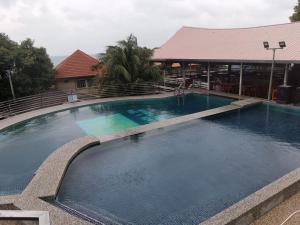a large swimming pool in front of a building at River Side Chalet Tioman in Kampung Genting
