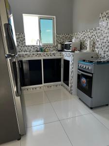 una cucina con piano cottura e frigorifero di Chrewans Enterprise Ltd a Montego Bay