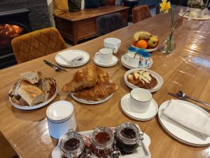 a table with a turkey and other food on it at Domaine de Corbelande in Miniac-sous-Bécherel